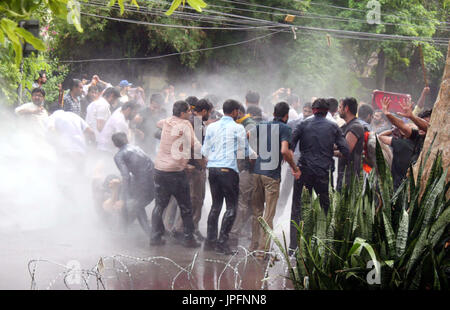 Police officials restore baton charge and open water canon to repel protesters moving towards Red Zone during protest demonstration of Young Doctors Association (YDA) against Secretary Heath Department, near Governor House at Mall road in Lahore on Tuesday, August 01, 2017. Stock Photo