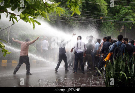 Police officials restore baton charge and open water canon to repel protesters moving towards Red Zone during protest demonstration of Young Doctors Association (YDA) against Secretary Heath Department, near Governor House at Mall road in Lahore on Tuesday, August 01, 2017. Stock Photo