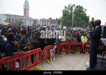London, UK. 1st Aug, 2017. People with banners and placards listen to Leo Muhammad in Brixton on1st August to counter African Holocaust (Maangamizi) denial and demand holistic reparatory justice for the African Holocaust., windrush square, brixton Credit: Thabo Jaiyesimi/Alamy Live News Stock Photo