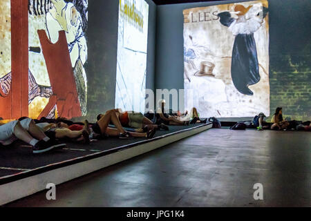 Berlin, Germany, 1st August 2017. People enjoy a multimedia video art show ‘From Monet to Kandinsky.Visions Alive’ . The exhibition presents the works of 16 Modernist artists on 7 meter screens placed at different angles in two viewing rooms. Credit: Eden Breitz/Alamy Live News Stock Photo
