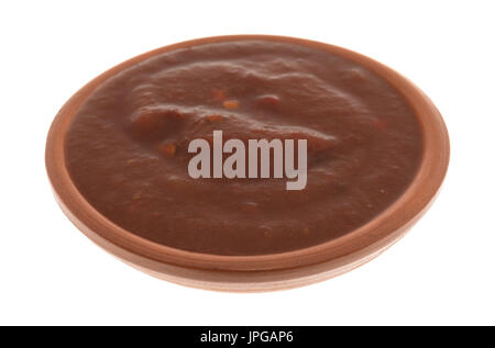 A small bowl of adobo sauce isolated on a white background. Stock Photo