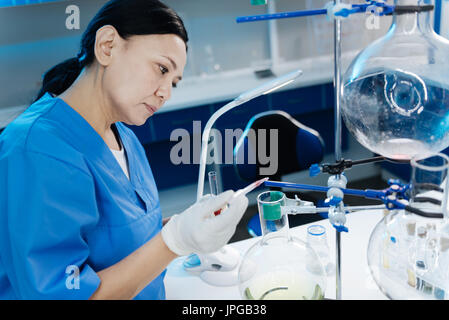 Serious female researcher working in the scientific lab Stock Photo