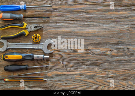 Tools on an old wooden background with copy space. Stock Photo