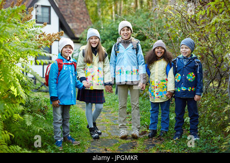 Group of adorable schoolkids standing not far from their school Stock Photo
