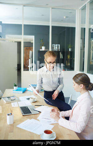 Two female employers discussing resume of applicants before or after interview Stock Photo