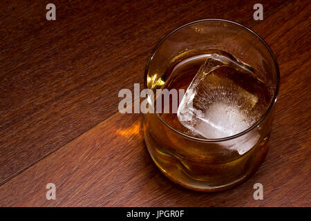 blended scotch whiskey served in a short glass with a large ice cube  isolated on a white background Stock Photo - Alamy