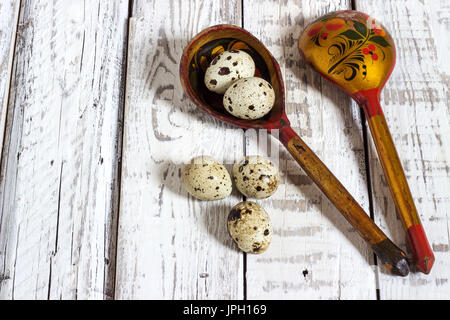 quail eggs in a wooden spoon on old wooden background Stock Photo