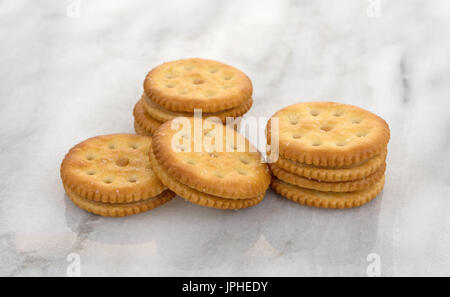 Several roasted peanut butter crackers on a gray marble table top. Stock Photo