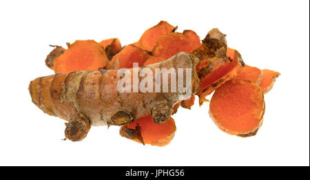 A whole fresh turmeric plus several slices isolated on a white background. Stock Photo
