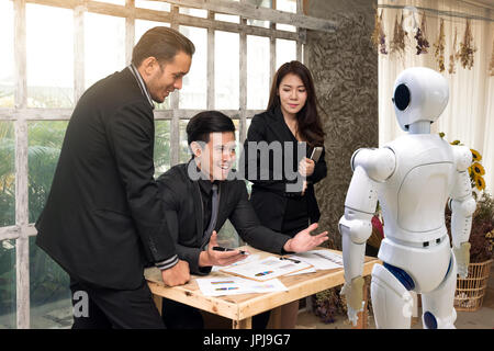 Business people team , manager and personal assistant automation robot video camera conference technology discussing together in conference room durin Stock Photo
