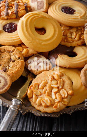 Biscuit mix with various fillings on a plate close up, vertical Stock Photo