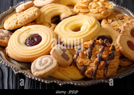 Cookie mix with nuts, chocolate, jelly closeup on a plate, horizontal Stock Photo