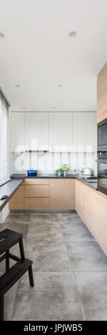Vertical panorama of modern kitchen with wooden furniture Stock Photo