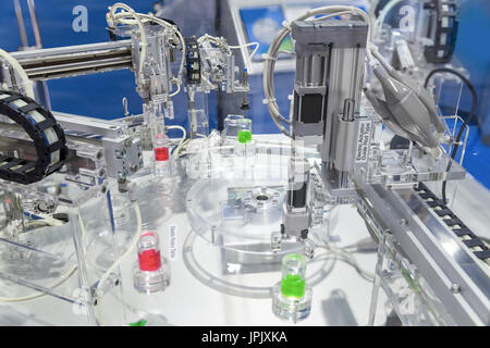 Parallel type Air Gripper, Vacuum Pad and Electric Actuator Guide Rod Type on Rotary table in Automatic robot chemical production line for research la Stock Photo