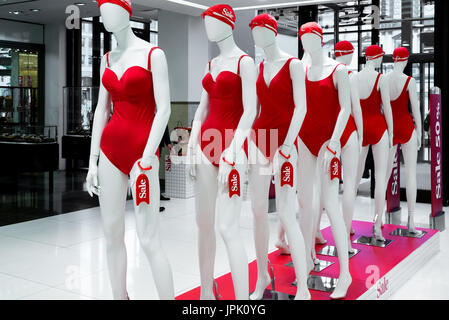 A series of mannequins in red swimsuits.Sale Stock Photo