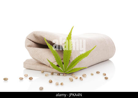 Hemp cloth production, cloth with cannabis leaf and seeds, isolated on white background. Stock Photo