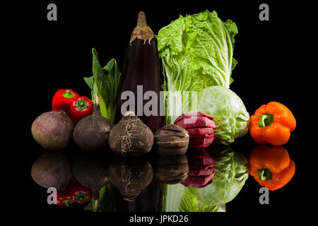 Luxurious colorful fresh vegetable isolated on black background. Beet, capsicum, cabbage, chinese cabbage, fennel, black radish and eggplant. Fresh he Stock Photo