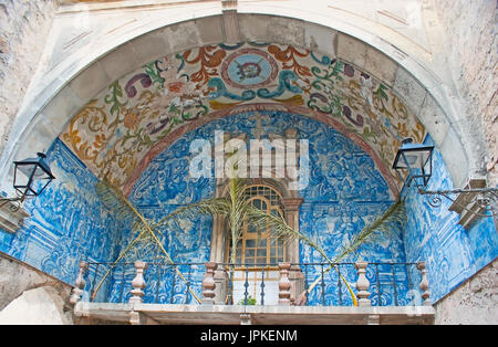 OBIDOS, PORTUGAL - APRIL 30, 2012: The decoration of the medieval city gate - painted floral patterns and pictures of handmade azulejo tiles, on April Stock Photo