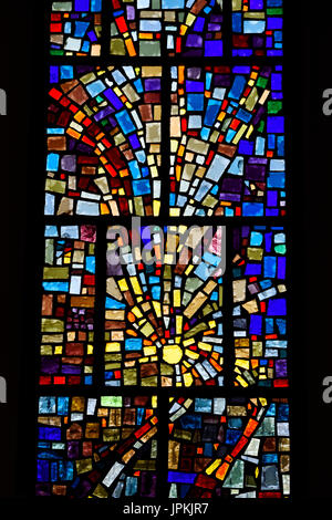 Abstract multicolor sun pattern of a stained glass window mosaic in a Toronto Roman Catholic church Stock Photo