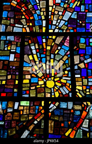 Abstract sun pattern of colors in a stained glass window mosaic in a Toronto Roman Catholic church Stock Photo