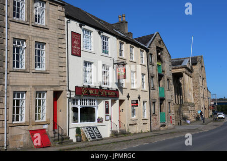 View along St George's Quay in Lancaster past various buildings including the George and Dragon pub, converted old warehouses and Maritime museum. Stock Photo