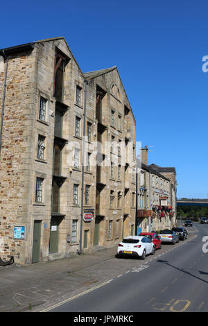 View along St George's Quay in Lancaster past converted old warehouses on the quayside of the River Lune. Stock Photo