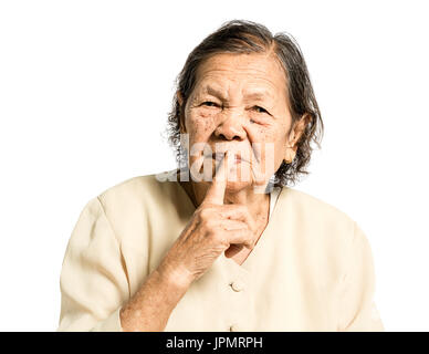 portrait of a senior woman smiling and whispering. Isolated on white background Stock Photo