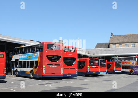 Double decker and single deck Stagecoach liveried busses at one side of Lancaster bus station waiting at stands for passengers and their next service. Stock Photo