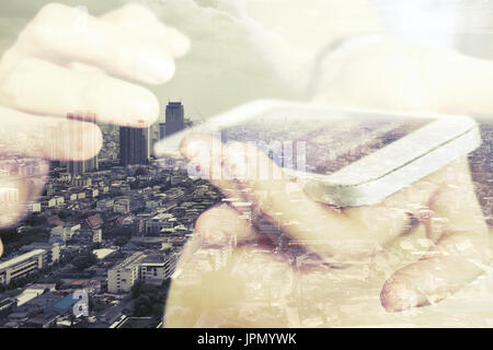 Double exposure of man using smart phone and cityscape background ,Business technology concept. Stock Photo