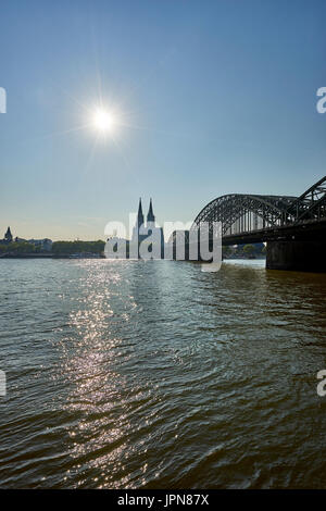 Cologne/Germany - May 10, 2017:Cologne Cathedral in view past Hohenzollern Bridge as seen from Kennedy Ufer/ riverbank Stock Photo