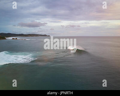 Surfer in Nicaragua on big wave aerial drone view Stock Photo