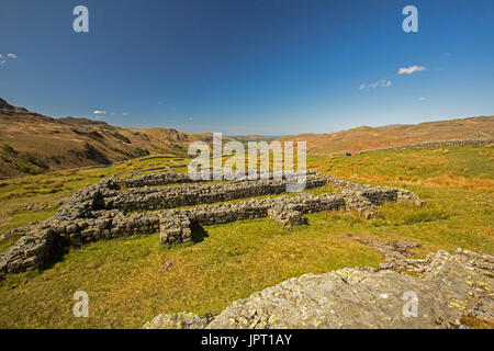 Ruins of Roman fort under blue sky at Hardknott pass, on hillside in Lake District National Park, Cumbria, England Stock Photo