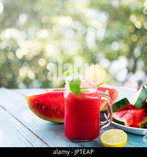 Watermelon cocktail on blue table, close-up Stock Photo
