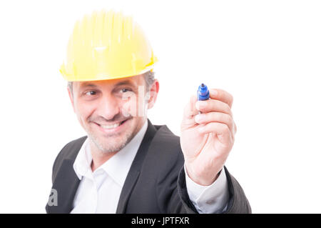 Selective focus of contractor wearing hardhat writing with marker and smiling isolated on white background Stock Photo