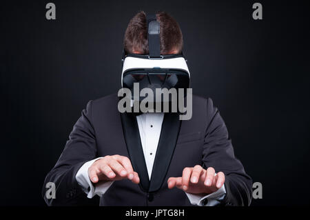 Exclusive man using virtual reality headset and typying on imaginary keyboard Stock Photo