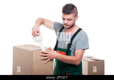 Mover guy using duct tape on cardboard box isolated on white background Stock Photo
