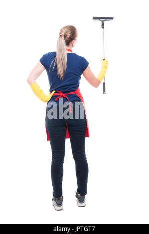 Back view of young housewife  with scraper washes the windows on white background Stock Photo