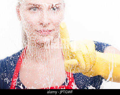 Female housekeeper touching the glass with foam in close up view isolated on white background Stock Photo