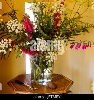 Flowers and scissors on table Stock Photo