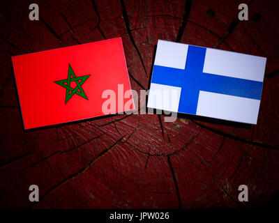 Moroccan flag with Finnish flag on a tree stump isolated Stock Photo