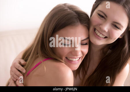 Portrait of two happy young women embracing Stock Photo