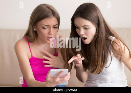 Women shocked because of great online sale Stock Photo