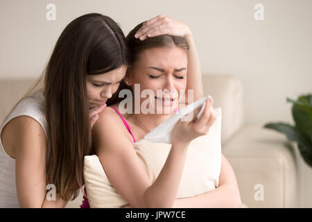 Young woman tries to comfort crying female friend Stock Photo
