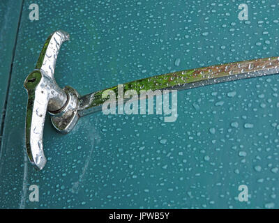 raindrops on pristine duck egg blue paintwork of classic car with chrome fittings Stock Photo