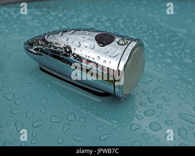 raindrops on pristine duck egg blue paintwork of classic car with chrome fittings Stock Photo