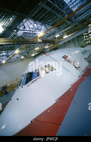 engineers working on a British Airways Boeing 747-400 in a maintenance hangar Stock Photo