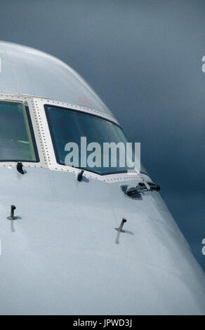 windshield and pitot-tubes on nose of an United Airlines Boeing 747-400 with dark clouds behind Stock Photo