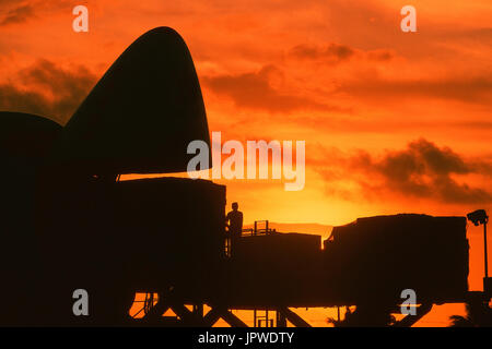 cargo being loaded into open nose cargo door of a Southern Air Transport Boeing 747 at dusk Stock Photo