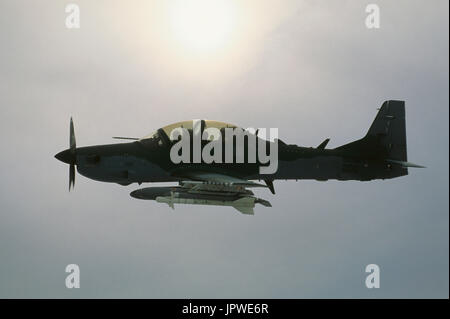 Brazilian Air Force Embraer EMB-314 Super Tucano flying with clouds Stock Photo