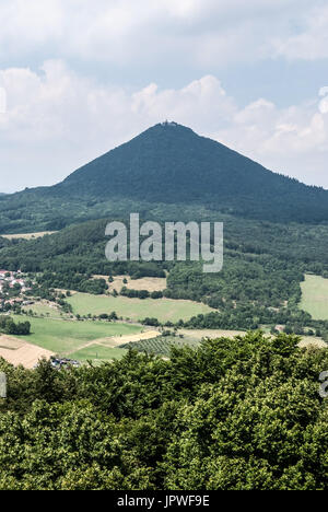 highest hill of Ceske stredohori mountains named Milesovka from Ostry hill near Lovosice city in Czech republic during nice summer day with blue sky a Stock Photo